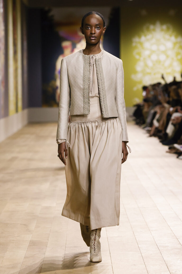 Diamond-pattern jacquard jacket embroidered with braids over beige shantung silk skirt and silk georgette shirt.