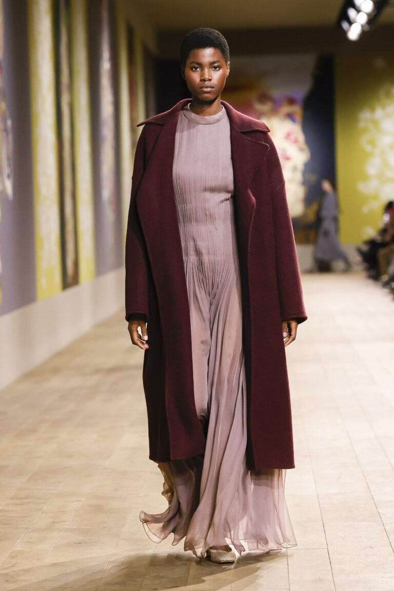 Cashmere coot with burgundy astrakhan effect over taupe silk chiffon dress.