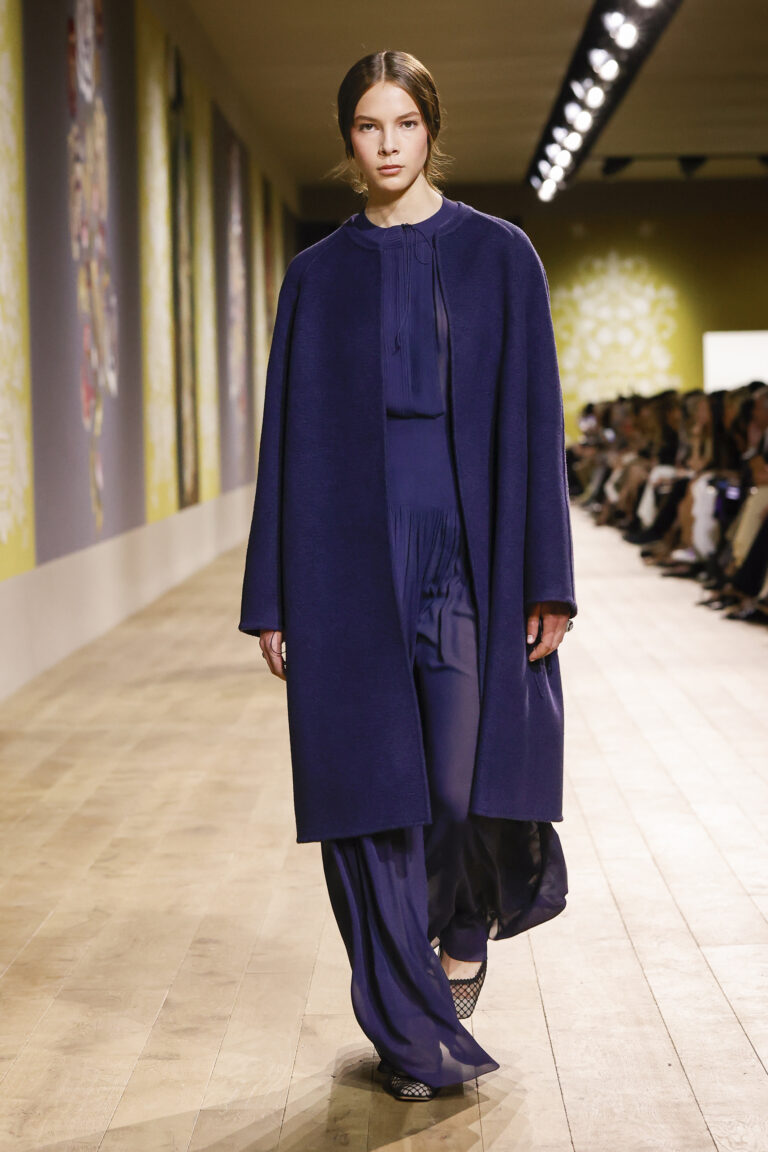 Cashmere coot with navy astrakhan effect over pleated skirt and navy silk georgette shirt.